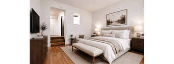 A modern bedroom with a large bed, a wooden dresser, and a flat-screen TV.