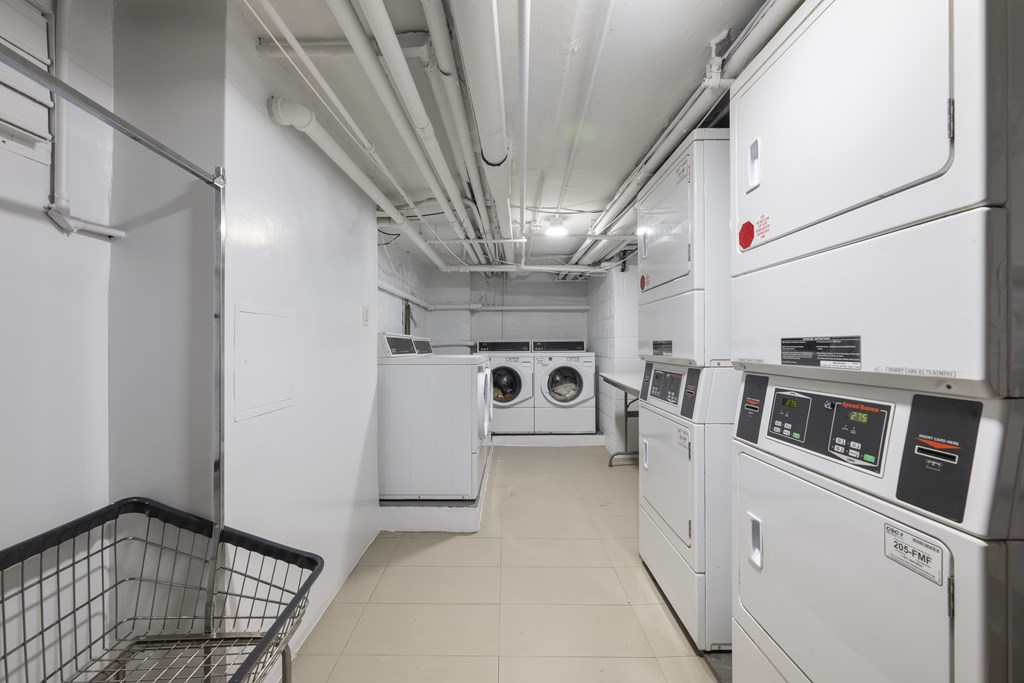 A laundry room with washers and dryers.