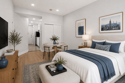 A bedroom with a large bed and a small table with a plant on it.
