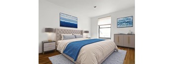 A bedroom with a large bed and a blue blanket.