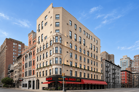 A tall building with a red awning in front of it.