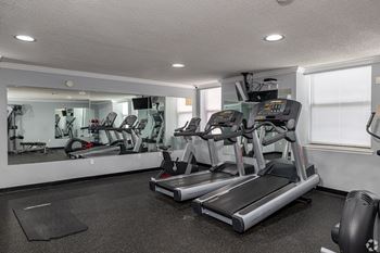 A gym with treadmills and exercise equipment.