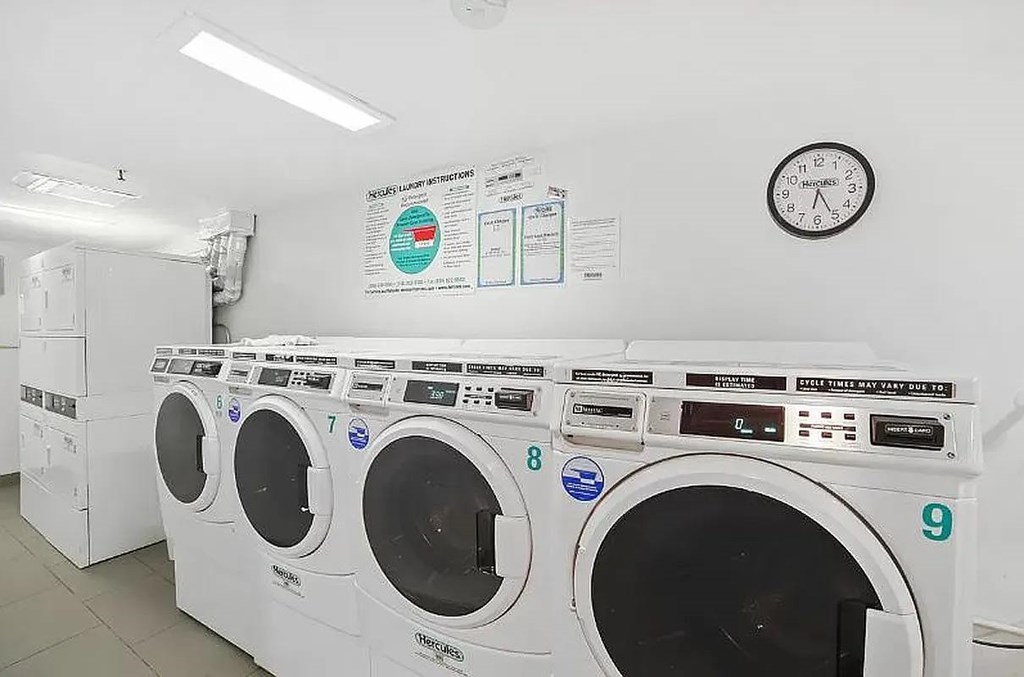A row of washing machines in a laundromat.