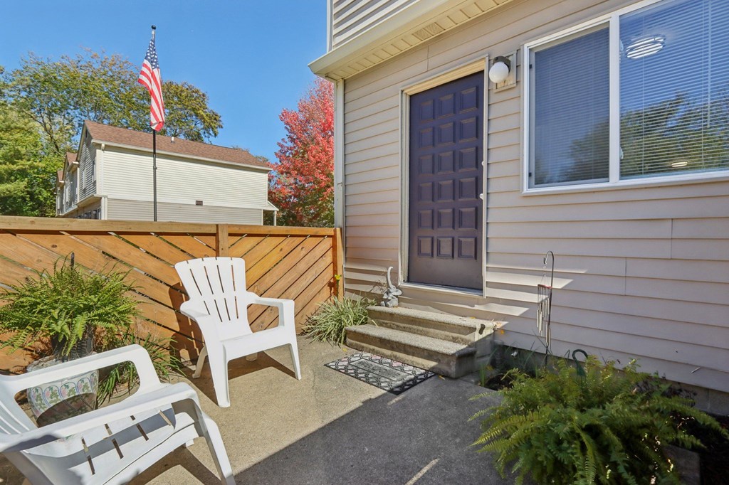 A small patio with a chair and a table.