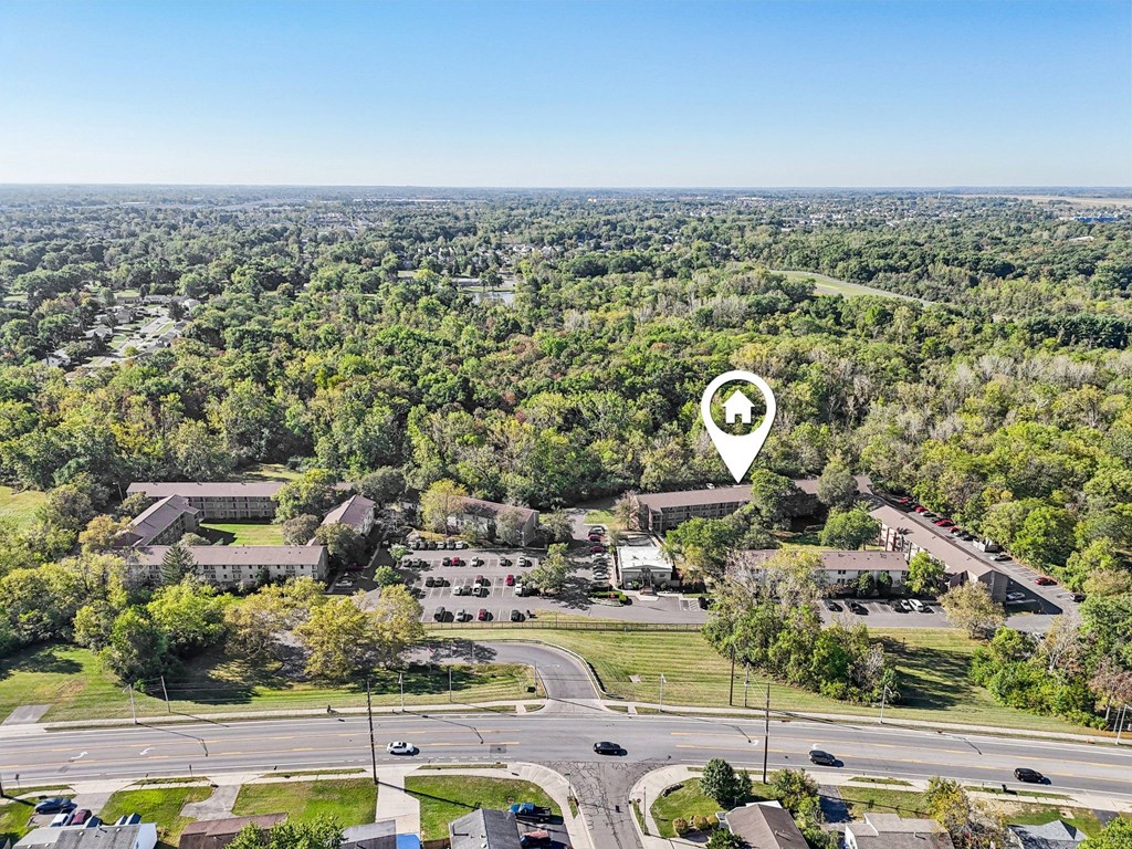 A bird's eye view of a residential area with a road and houses.