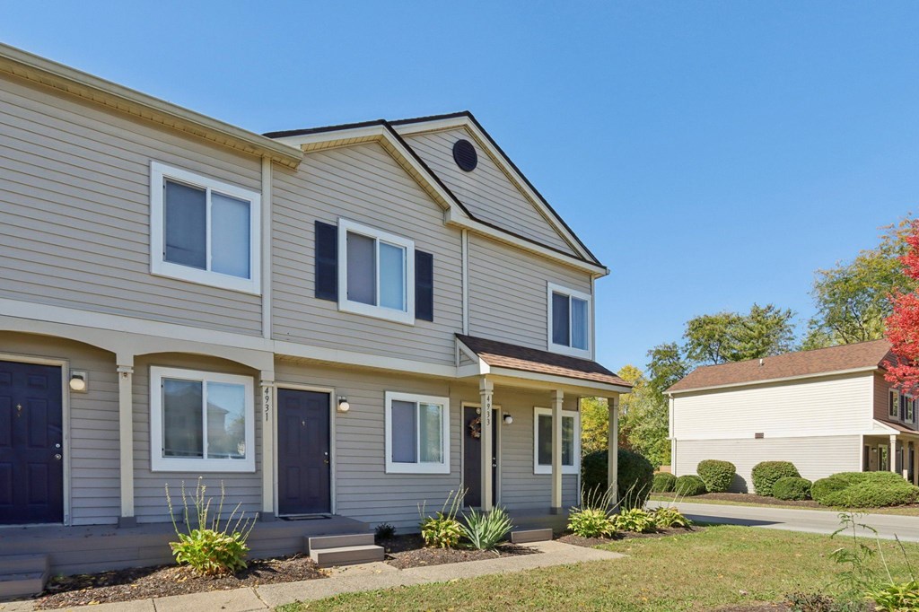 A two-story house with a grey and beige exterior.