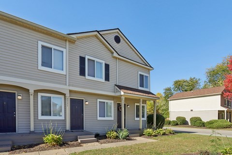 A two-story house with a grey and beige exterior.