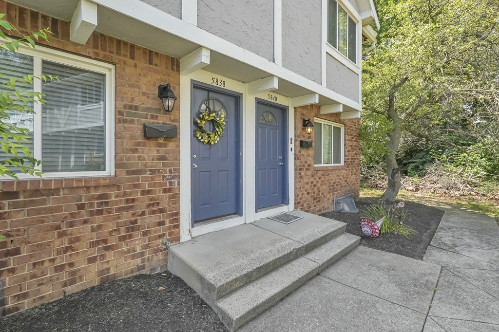 A house with a blue door and a wreath on it.