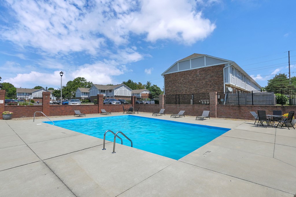 A large swimming pool with a metal ladder in the middle of it.