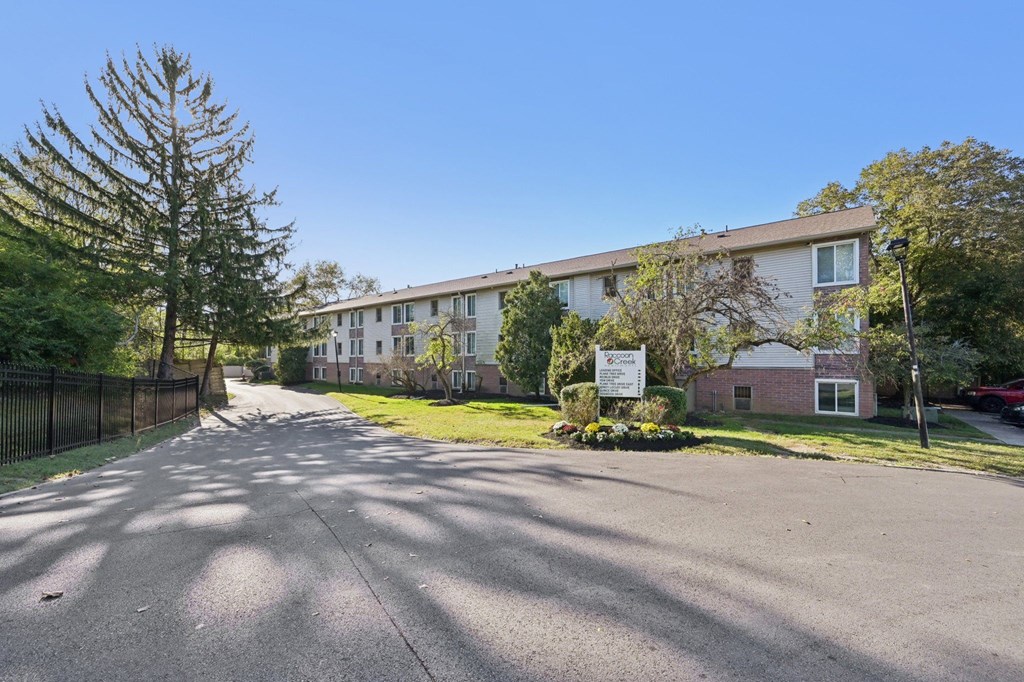 A sunny day at a residential street with apartment buildings on the side.