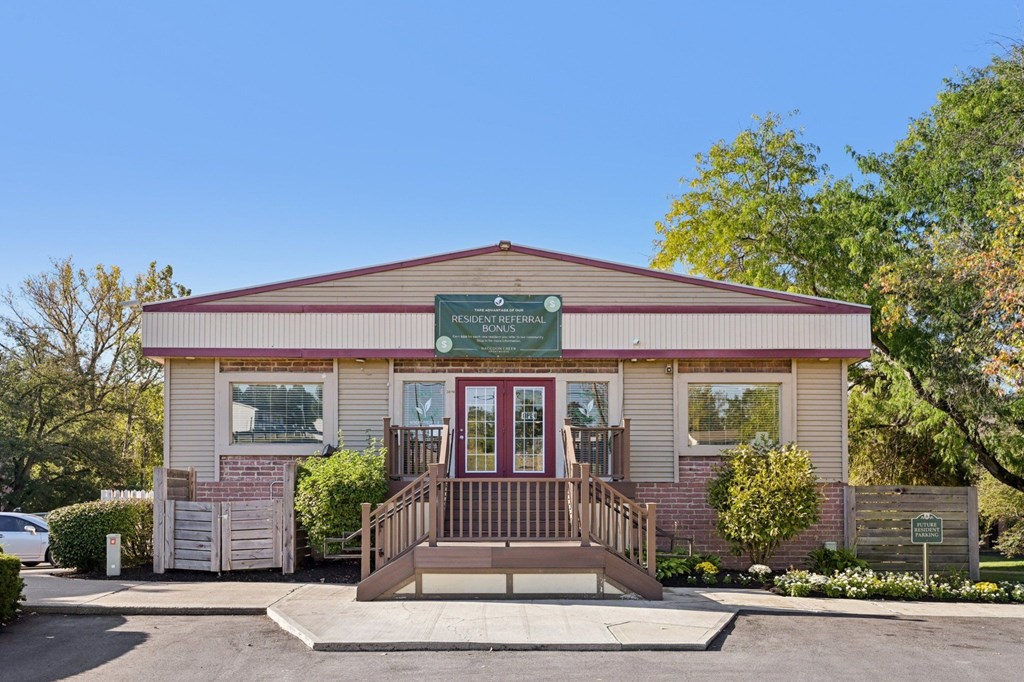 A small building with a green sign on the front.