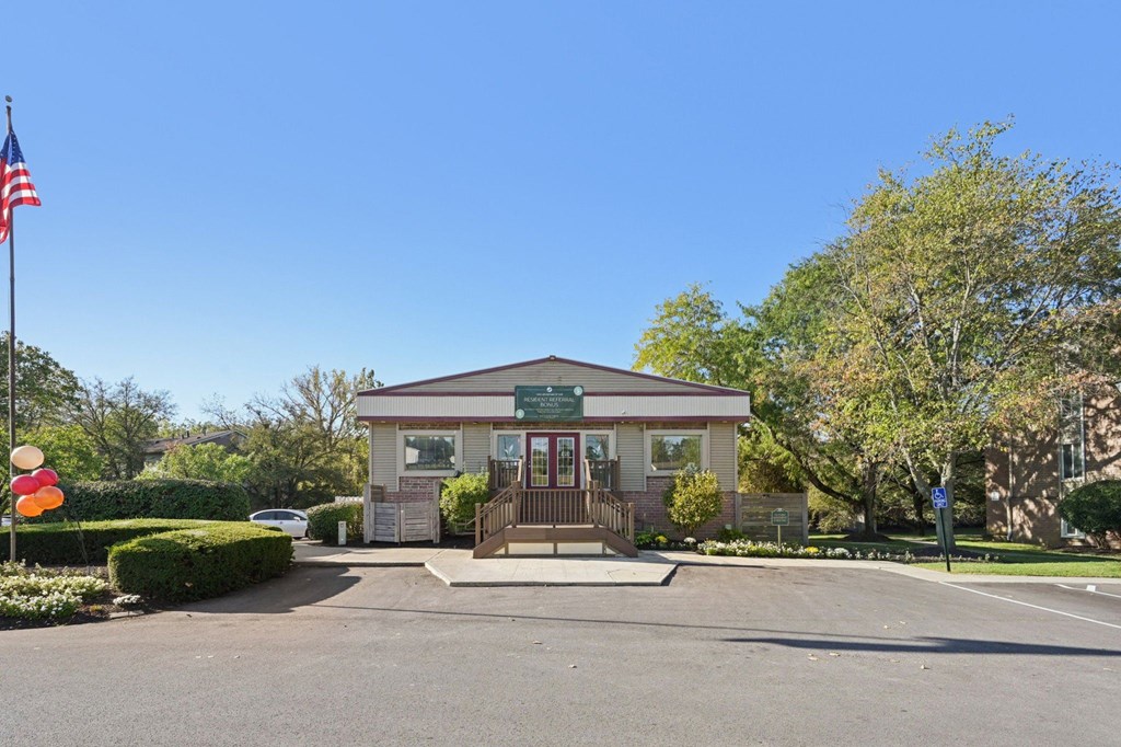 A building with a green signboard and a flag on the left side.