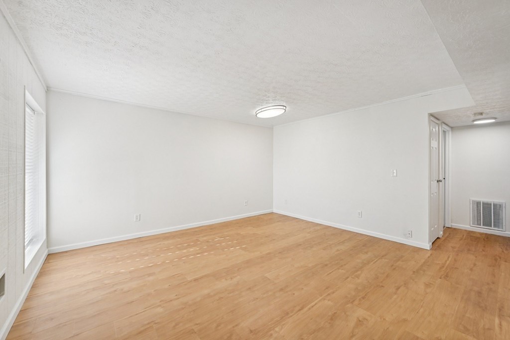 A room with wooden floors and white walls.
