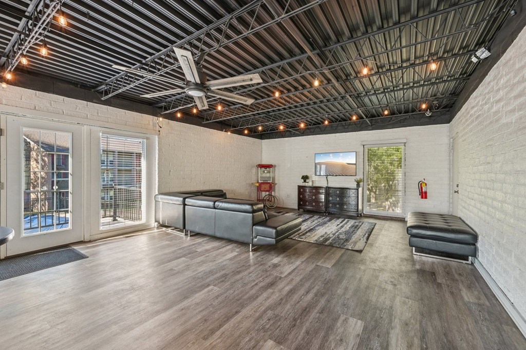 A room with a wooden floor and a ceiling with lights.