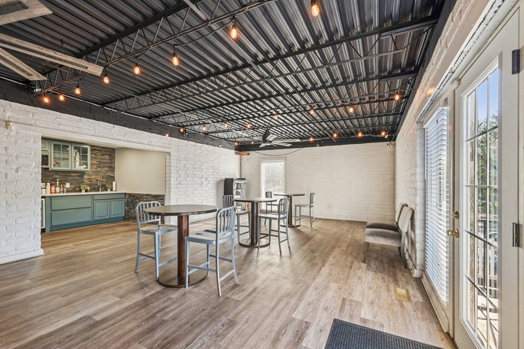A room with a wooden floor and a ceiling with lights.