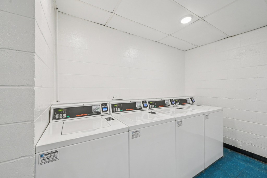 A row of washing machines in a laundromat.