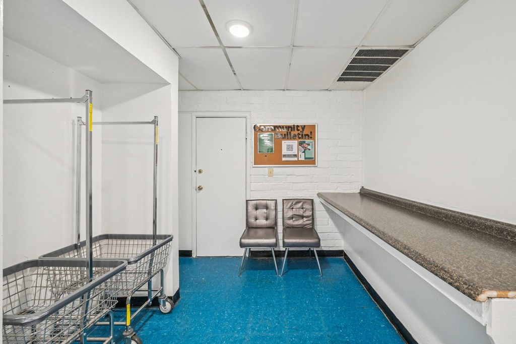 A room with a blue floor and a shopping cart.