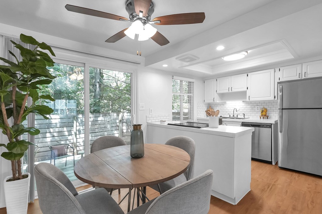 A modern kitchen with a dining table and chairs.