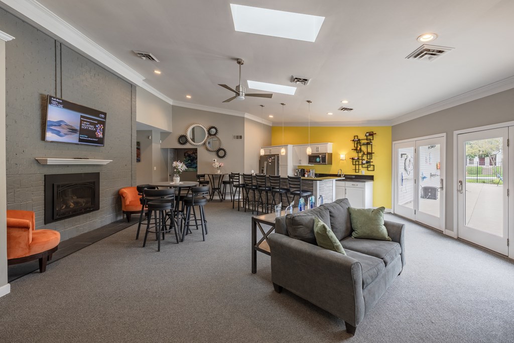 a living room with a couch and chairs and a fireplace