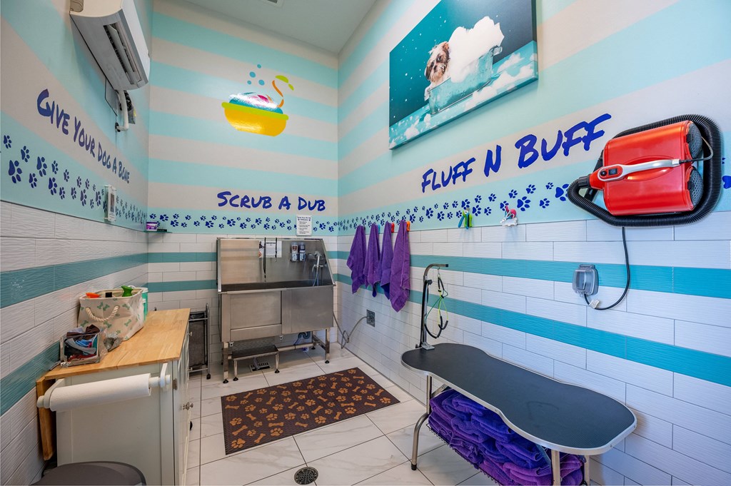 a laundry room with a sink and a ironing board