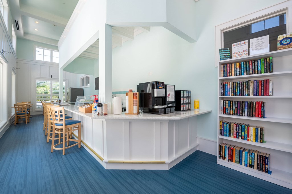 a library with a coffee bar and a table with chairs