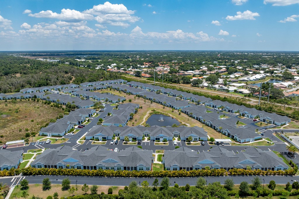 an aerial view of a parking lot filled with houses