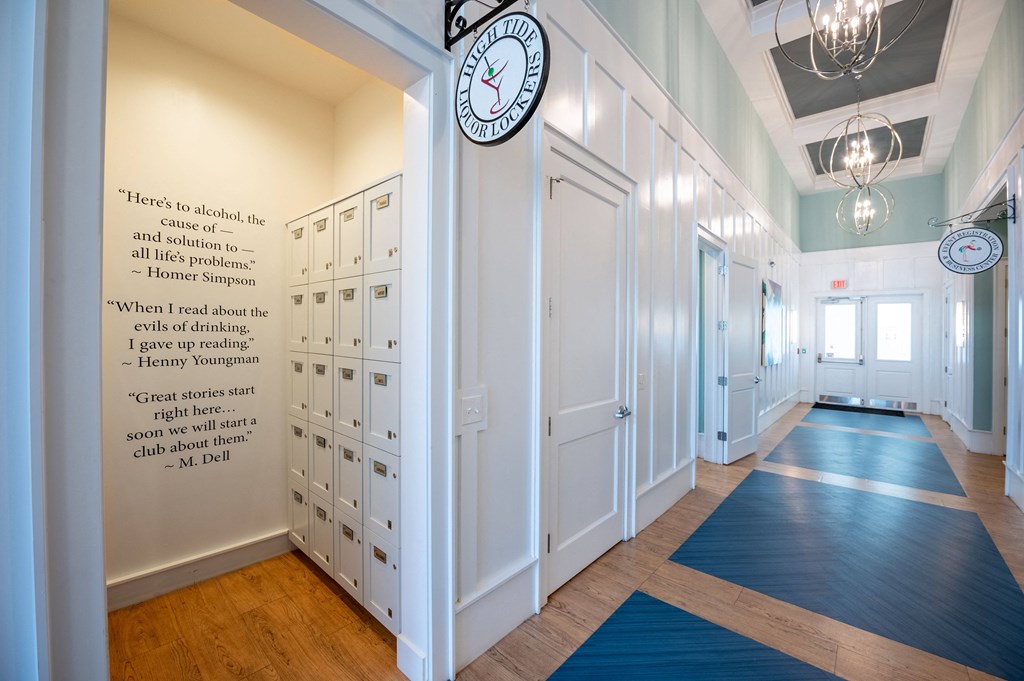 a hallway with rows of lockers and a clock on the wall