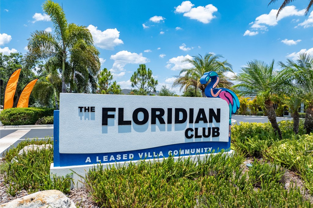 the sign a leased villa community with palm trees