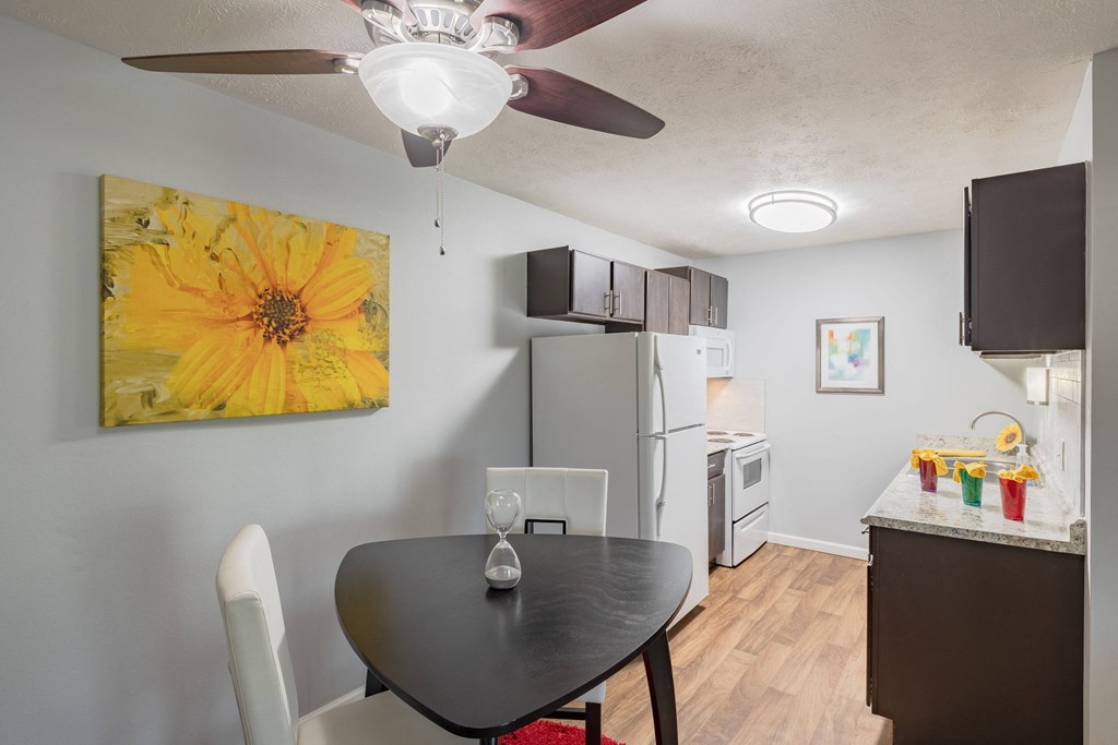 a living room with a dining room table and a kitchen