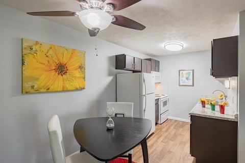 a living room with a dining room table and a kitchen