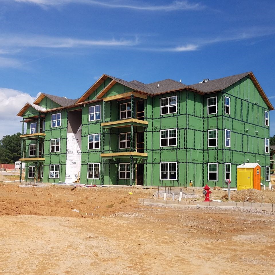 a green house being built with a fire hydrant