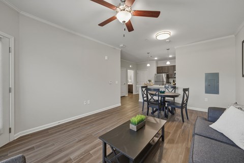 A living room with a dining table and chairs.