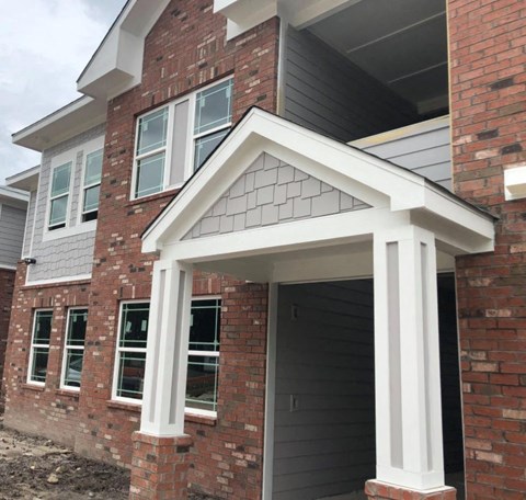 a new front porch is being installed on a brick house