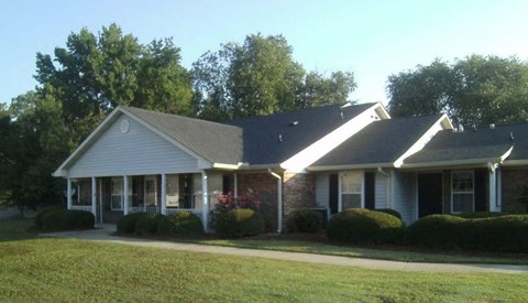 a house with a gray roof and a yard
