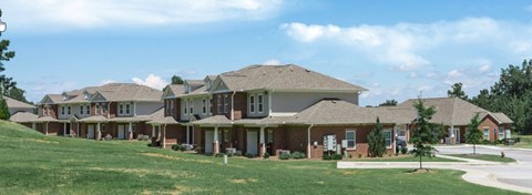 a row of houses in a neighborhood with grass and trees