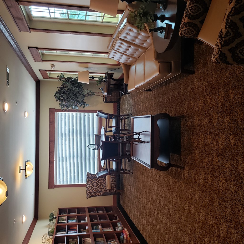 a view of a living room with a ceiling fan and a window