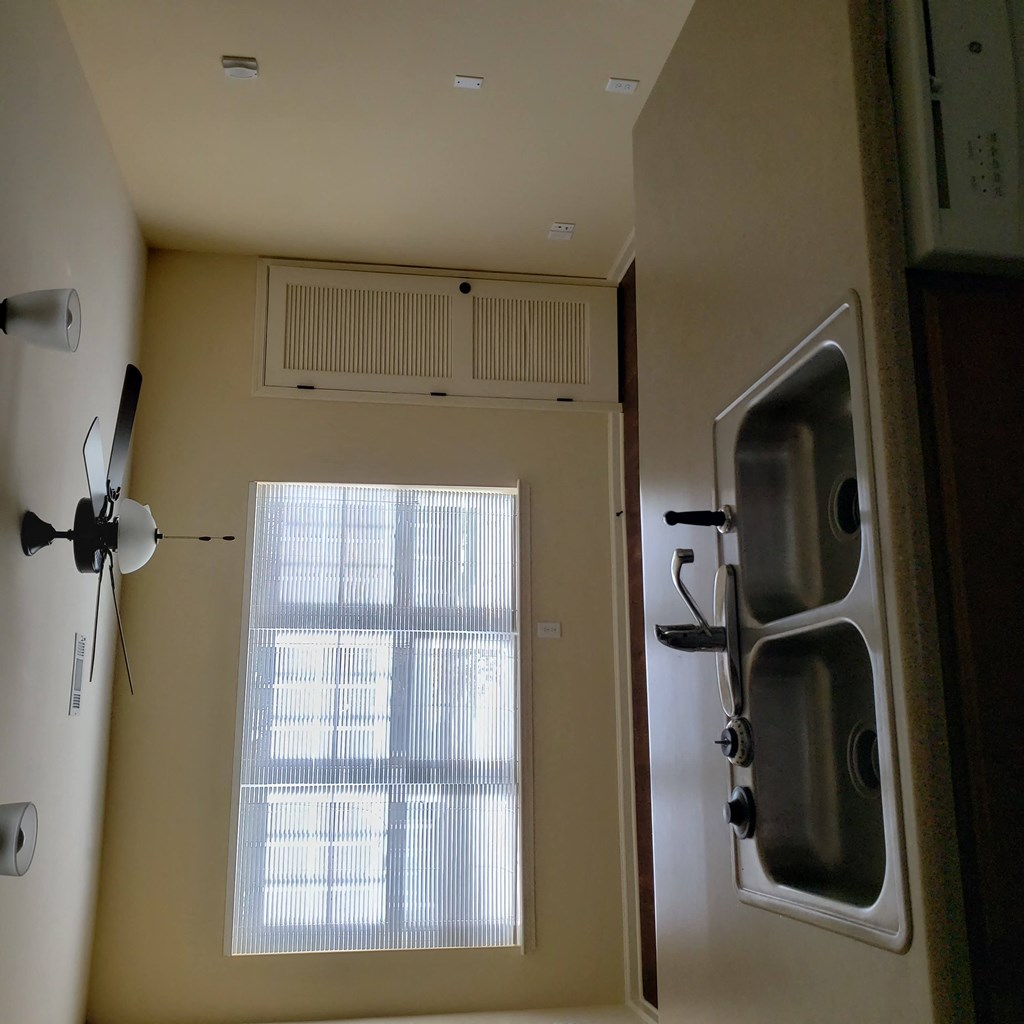 a kitchen with a window and a door and a sink