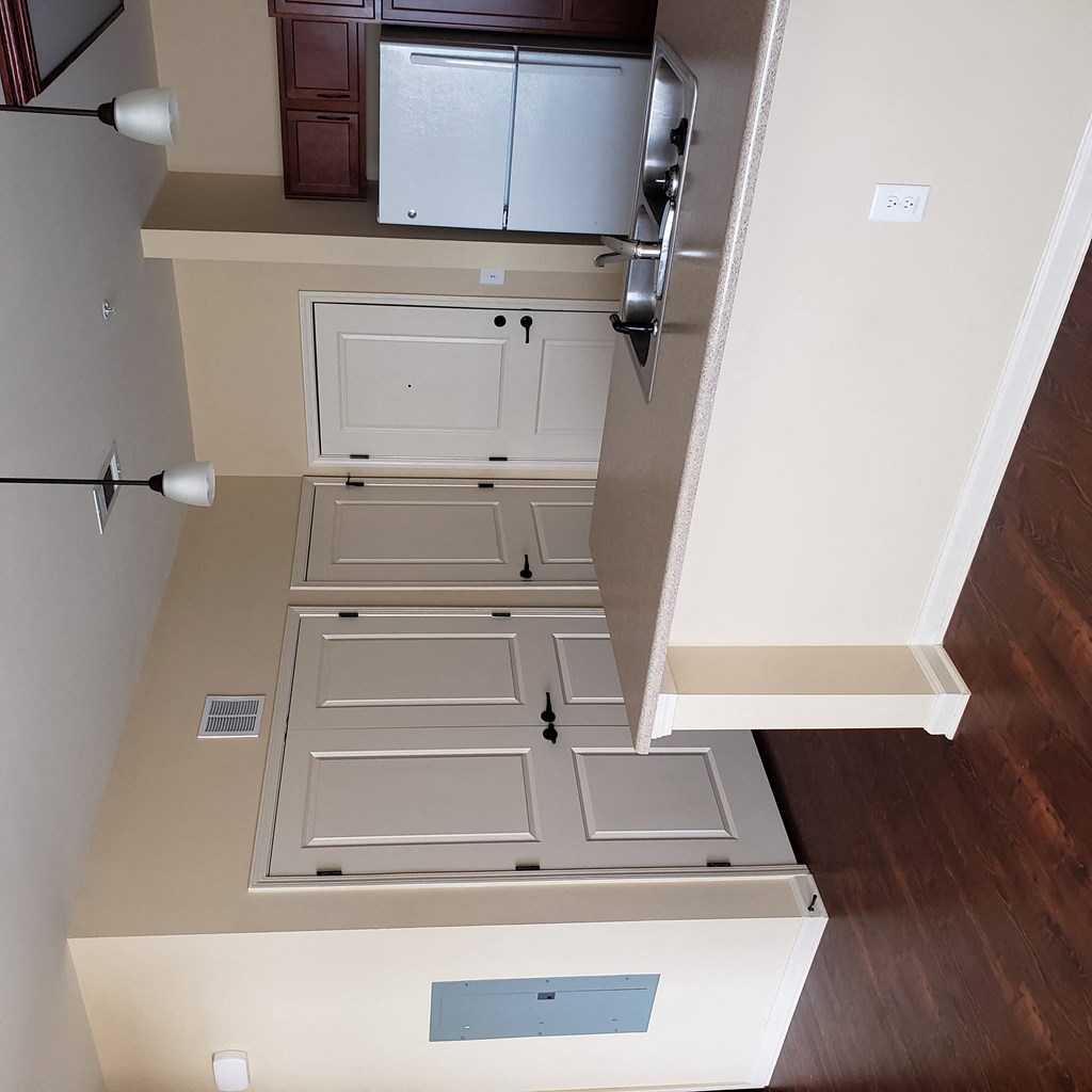 a look at the bottom of a staircase with drawers and cabinets
