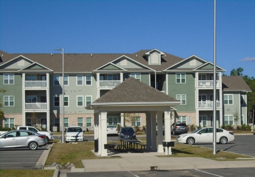 a gazebo in front of an apartment building