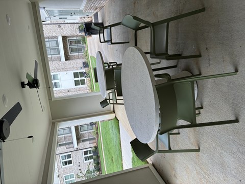 A modern outdoor furniture set is displayed on a concrete wall.
