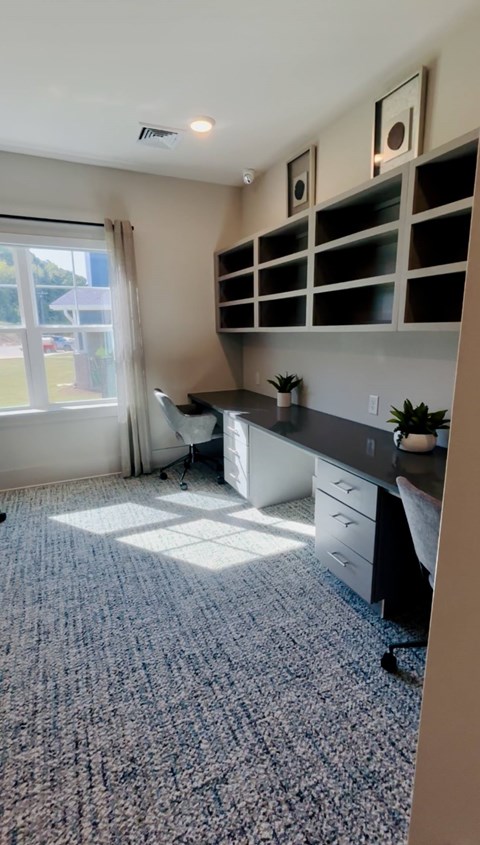 A room with a desk and a window.