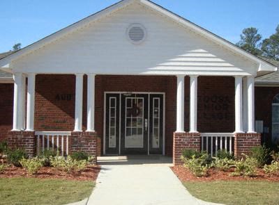 a house with a front porch and a sidewalk