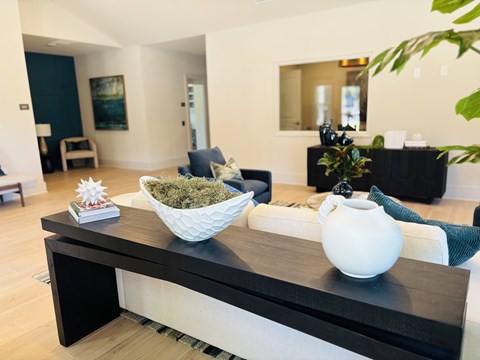 A living room with a black and white coffee table.