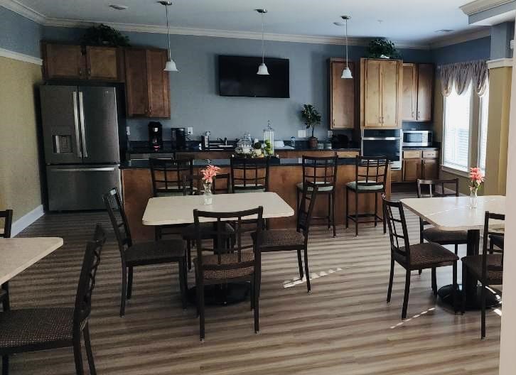 A kitchen with a table and chairs in the middle of the room.