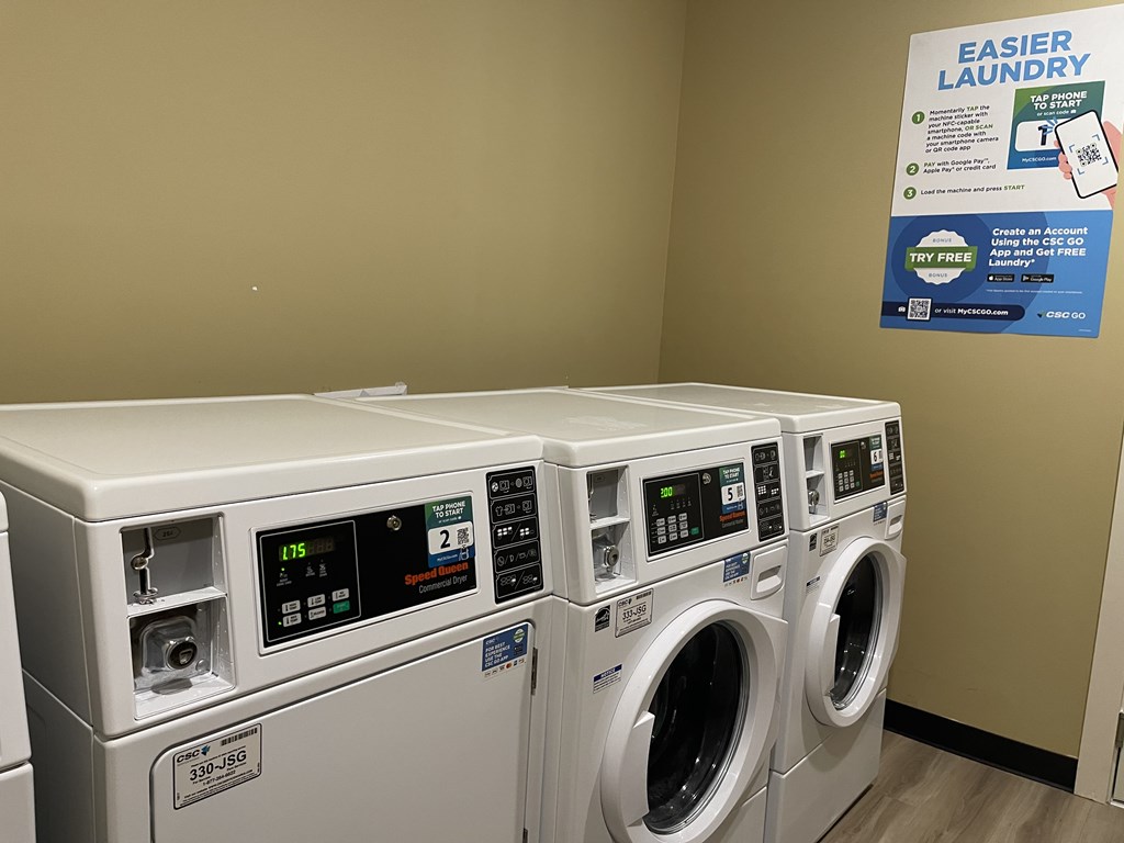A row of washing machines in a laundromat.