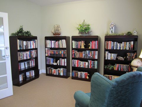 Four bookshelves filled with books and decorative items.