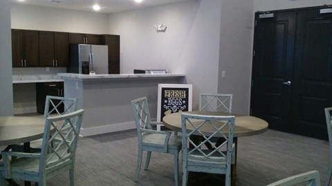 a dining room with a table and chairs and a kitchen