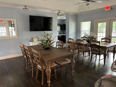 A dining room with a wooden table and chairs.