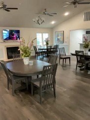 A dining room with a table and chairs.