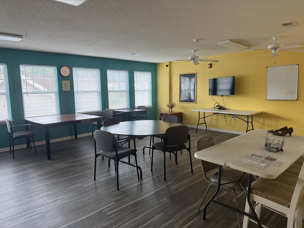 A room with a table and chairs in it.